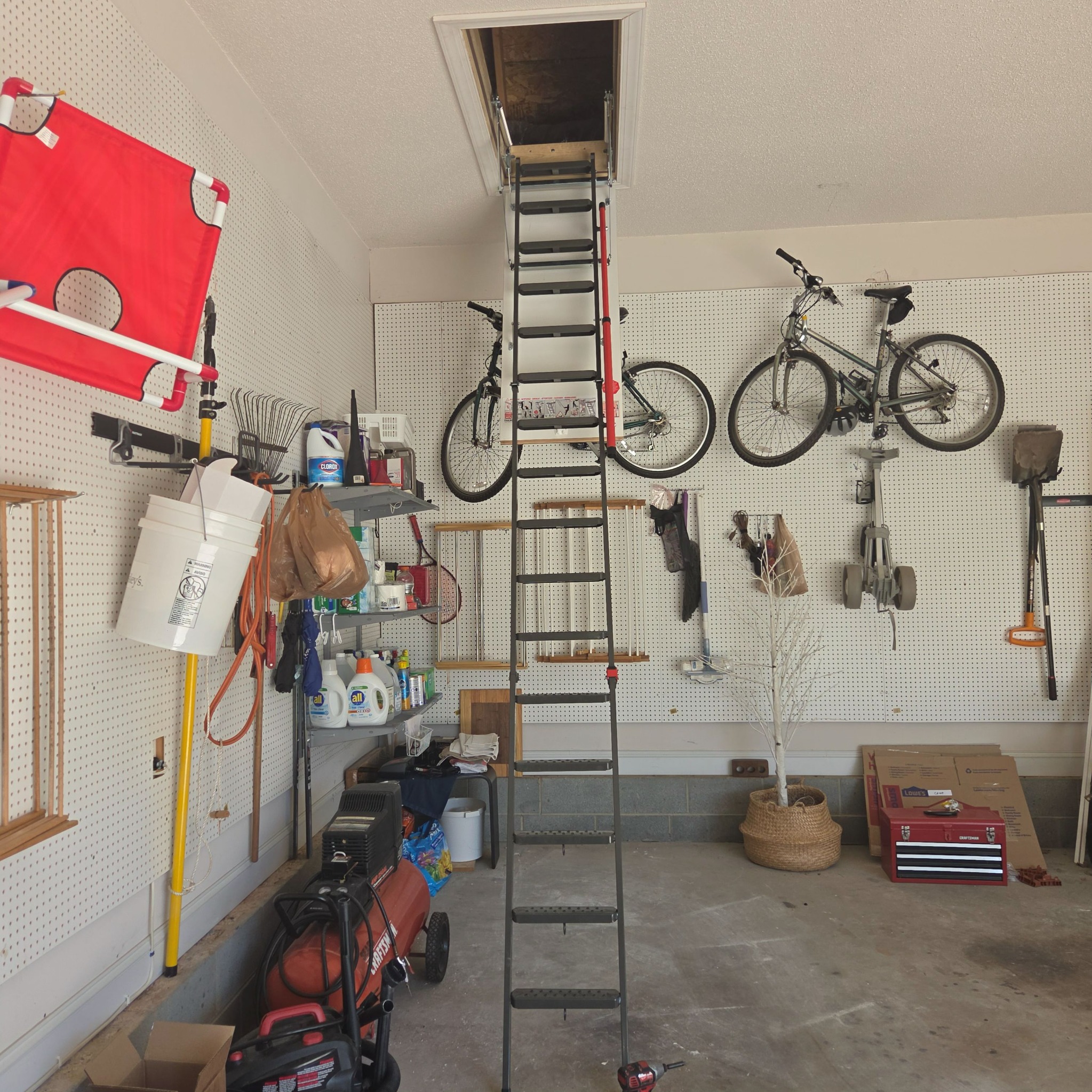 High-ceiling attic ladder installed by RYN Services in a garage