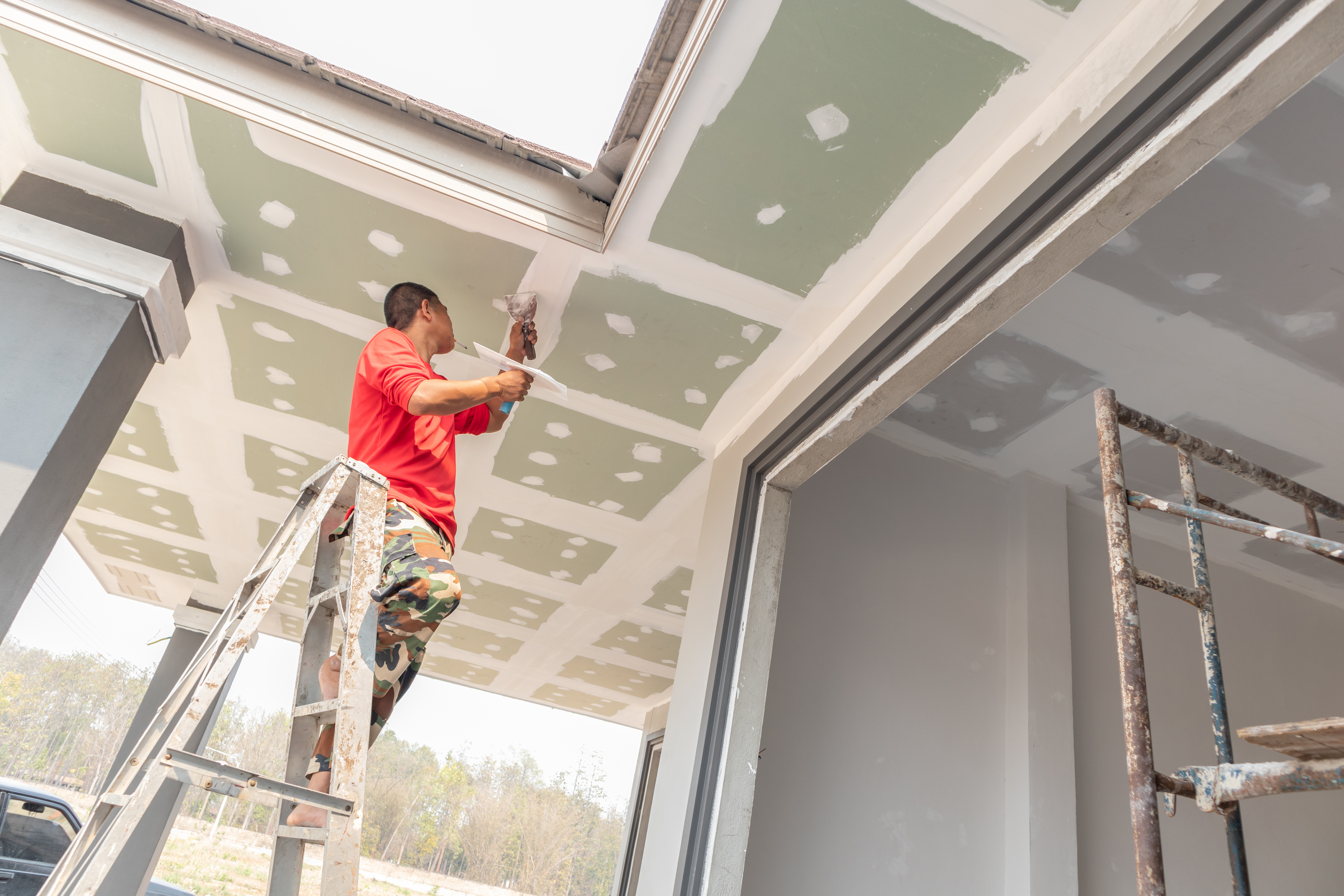 Drywall repair person doing a repair